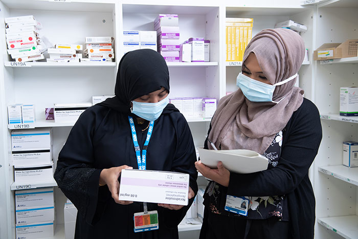 two people working in a pharmacy premises